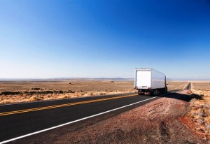 Utah, USA --- Semi Truck Driving on Desert Highway --- Image by © Steve Craft/Corbis